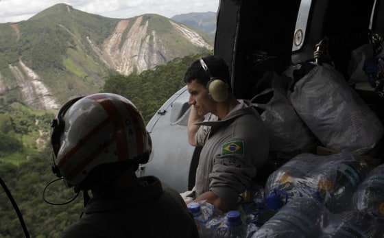 Image: Brazilian Navy soldiers take part in an operation to distribute donations to residents of landslide affected areas in Nova Friburgo