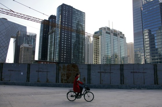 Image: Cyclist passes new consruction in Beijing