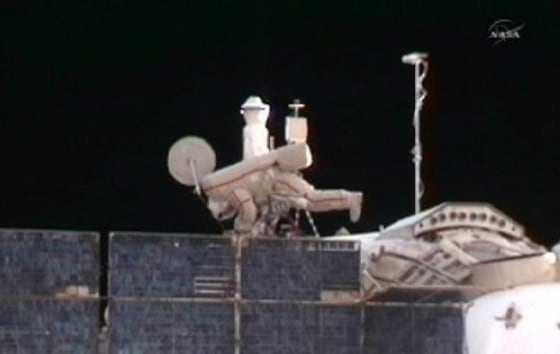 Image: Russian cosmonaut Kondratyev works to install an experimental Russian radio transmission system during their spacewalk outside the International Space Station
