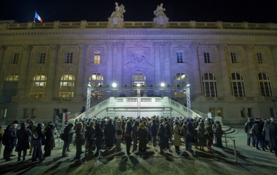 Image: People queue outside the Grand Palais to view the Monet painting exhibit in Paris