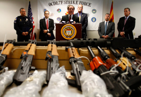 Image: District of Arizona United States Attorney Dennis Burke \speaks about recovering weapons from defendants accused of trafficking illegal firearms to Mexican drug cartels during a news conference in Phoenix