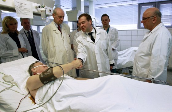 Image: Russia's President Medvedev shakes hands with a victim of a bomb explosion at Domodedovo airport at the N.V. Sklifosovsky Scientific Research Institute of First Aid in Moscow
