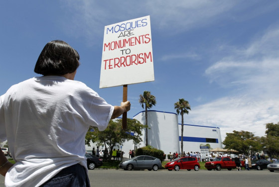 Image: Local citizens protest across the street from a business warehouse where the Islamic Center of Temecula Valley currently hold their services in Temlecula