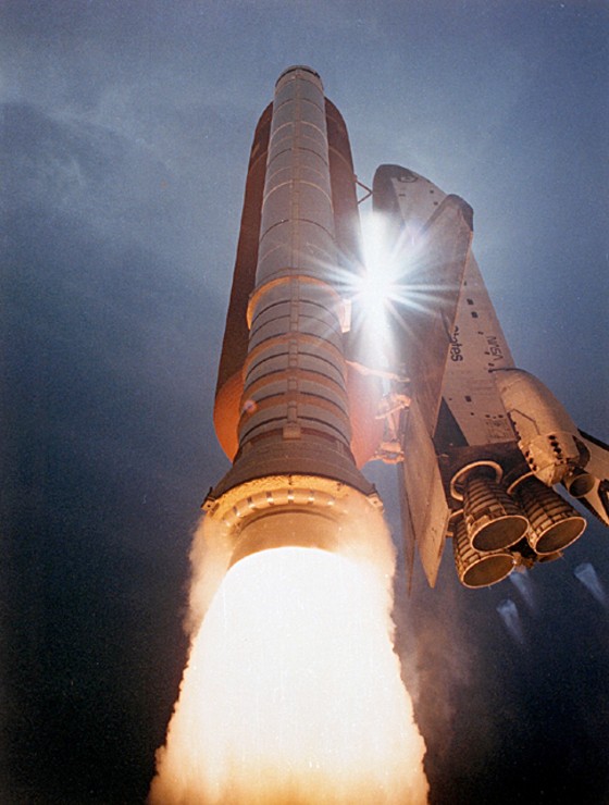 A space shuttle blasts into the sky during a launch from NASA's Kennedy Space Center in Florida.
