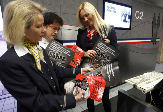Image: Flight attendants deliver educational materials at the Dallas Fort Worth International Airport in Dallas