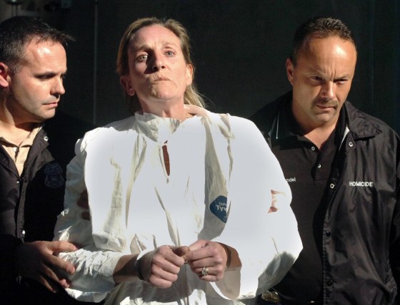 Image: Julie Powers Schenecker is led away from the Tampa Police Department