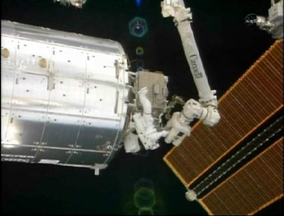 Image: Astronaut Steve Bowen works outside the Qwest airlock of the International Space Station.