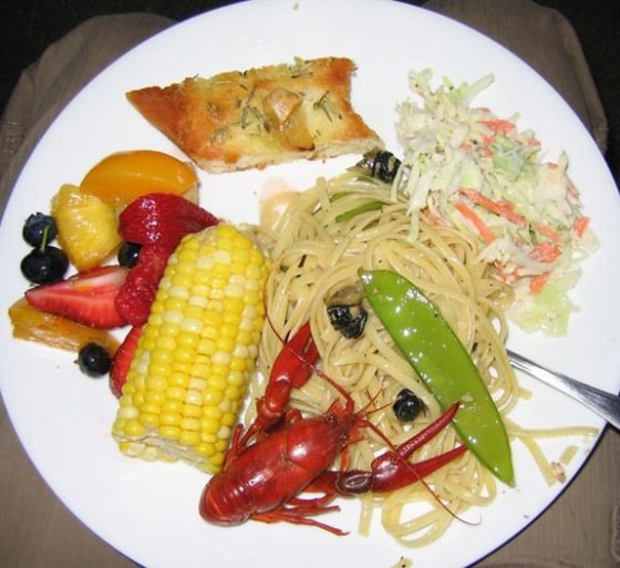 A fettuccine meal featuring the invasive Chinese mystery snail, with invasive Rusty crayfish on the side. The folks behind invasivore.org hope more people eat invasive species to stem their growth.