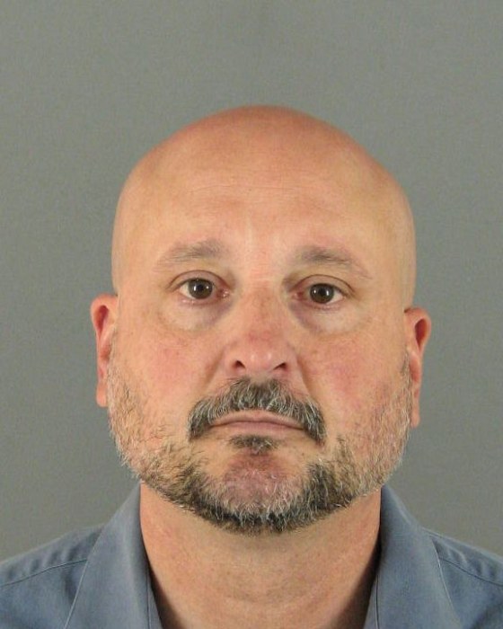Image: Michael Mangino, an Aurora, Colorado school policeman, is shown in this booking mug shot from the Aurora Police Department