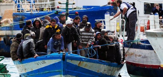 Image: Would-be immigrants in a boat are helped