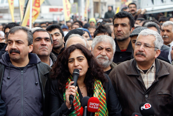 Image: BDP Parliamentarians Sebahat Tuncel (C) and Ufuk Uras (R) attend a protest against a High Election Board decision in central Istanbul on April 19