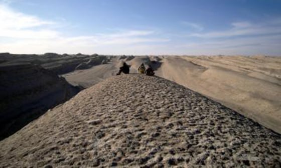 Image: What could have been. Researchers sit atop a wind-formed ridge in Central Asia.