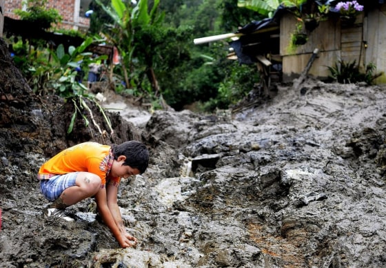 Image: A boy plays in the middle of a landslide in Sabaneta town north west of Colombia, on 25 April.