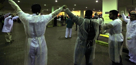 Image: Doctors form a human chain at Salmaniya Hospital fearing an attack by riot police in Manama
