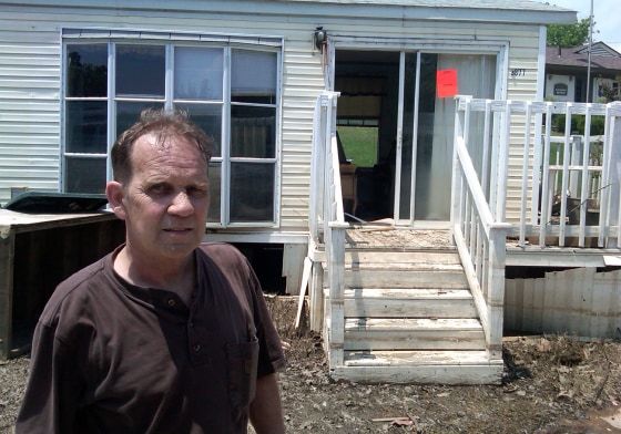 Image: Wesley Roberts, 59, stands outside of his flooded-out mobile home Tuesday in north Memphis, Tenn.