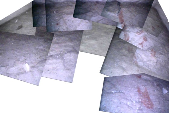 A composite of images taken by a robot of the floor of the Great Pyramid is shown. Red hieroglyphs are visible.