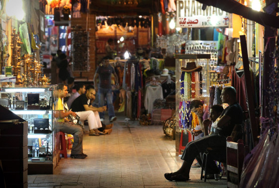 Image: Shop keepers wait for customers at night in Sharm El Sheikh