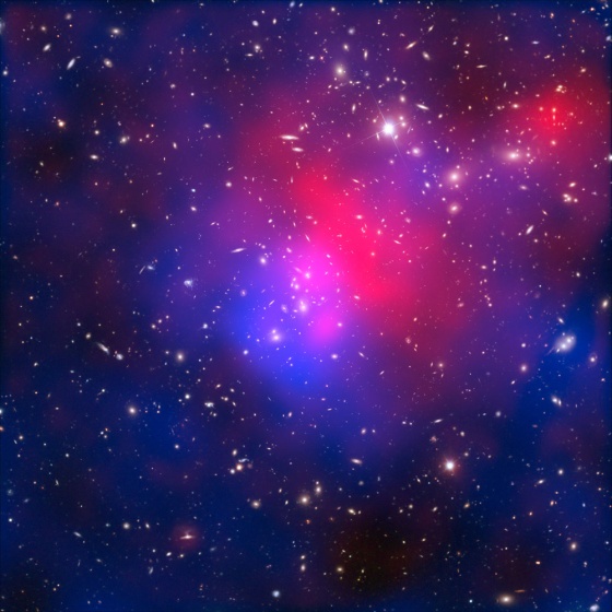 A composite image of galaxy cluster Abell 2744, also known as Pandora's Cluster, taken by the Hubble and Chandra space telescopes and the Very Large Telescope in Chile. Hot intracluster gas is shown in pink, and the blue overlay maps dark matter.