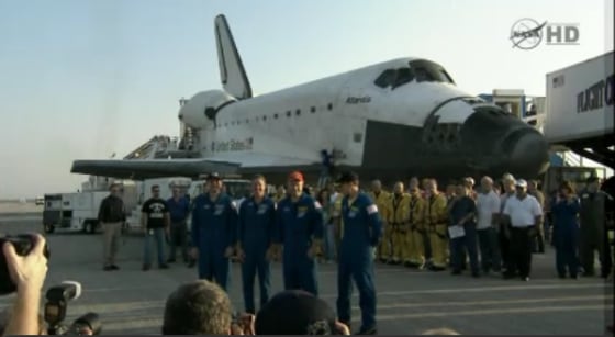 The Atlantis crew stands before the orbiter following their landing on Thursday.