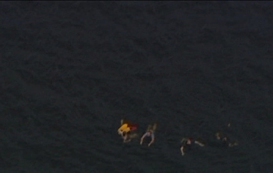 Image: An aerial view shows people swimming in the water close to Utoeya island after the shooting
