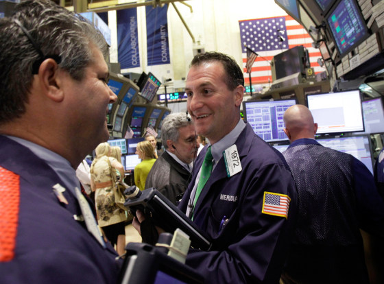 Image: Trader Jonathan Corpina, center, smiles as he works on the floor of the New York Stock Exchange
