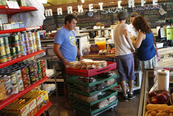 Image: Dino Curovac of Bread Basket Bakery pushes a cart of bread at the Phoenix Public Market in Phoenix