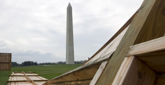 Image: A fallen wooden state park fences is seen on the ground near the Washington Monument
