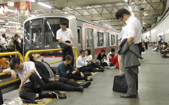 Image: Passengers wait for the resumption of train service after it was halted by Typhoon Roke, at Shibuya station in Tokyo