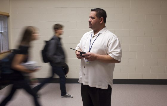 Image: School prinicpal watches students