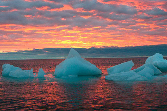 Ice chunks float in the Arctic Ocean as the sun sets near Barrow, Alaska. The Arctic is a thermostat against overheating and a barometer of change, but now its own protective ozone layer that keeps out damaging ultraviolet radiation has thinned to record levels, the U.N. weather agency has said.
