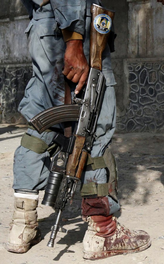 Image: Blood is seen on the leg of an Afghan policeman after a suicide bomb attack near a building used by the Office of the United Nations High Commissioner for Refugees (UNHCR) in Kandahar
