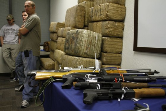 Image: Guns and bundles of marijuana seized from the Mexican Sinaloa Cartel during \"Operation Pipeline Express\" are displayed at a news conference in Phoenix
