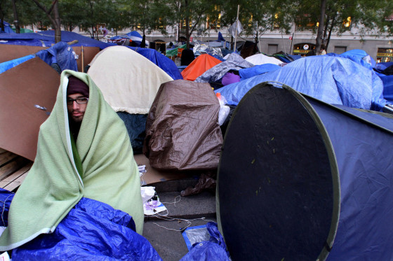 Image: Christopher Guerra, from San Franciso, Calif. is wrapped in a blanket to stay warm