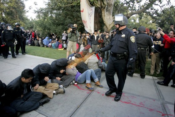 Image: A University of California Davis police officer pepper-sprays students during their sit-in at an \"Occupy UCD\" demonstration in Davis