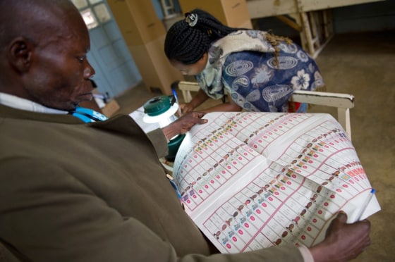 Image: A voter at the Imara polling station in Lubumbashi looks at a ballot page during presidential and parliamentary elections