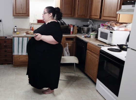 Image: Donna Simpson walks to the kitchen table with her breakfast at her home in Old Bridge