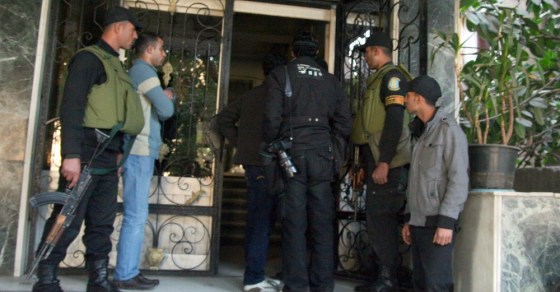 Egyptian military stand guard as officials raid a non-governmental organization offices in Cairo.