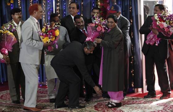 Image: A member of Bahujan Samaj Party (BSP) takes blessings of Mayawati, the chief minister of the northern Indian state of Uttar Pradesh, upon her arrival for a news conference in Lucknow