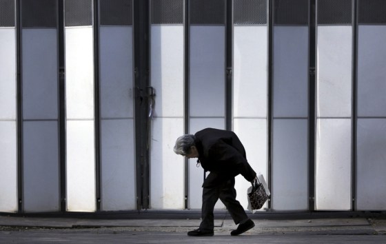 Image: An elderly woman walks in Tokyo