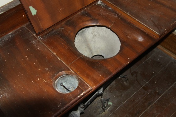 Pipes pumped water from the first-floor laundry to the attic, where the water stayed stored in large cisterns. Opening the faucets or yanking the toilet handle (on left) would allow the water to flow down into the bathroom fixtures. Waste would have been carried out of the pipes into a primitive septic system.