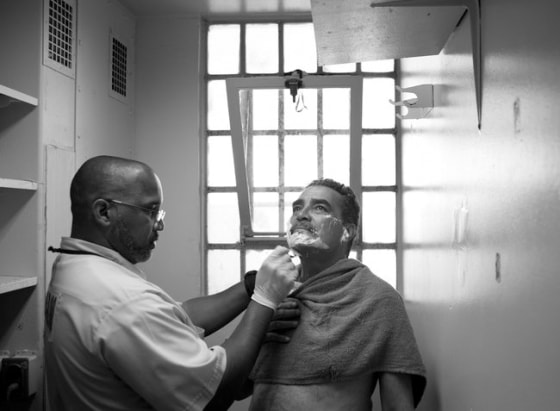 James Evers, an inmate at the California Men's Colony, shaves Joaquin Cruz, 60, a convicted killer with Alzheimer's disease. 