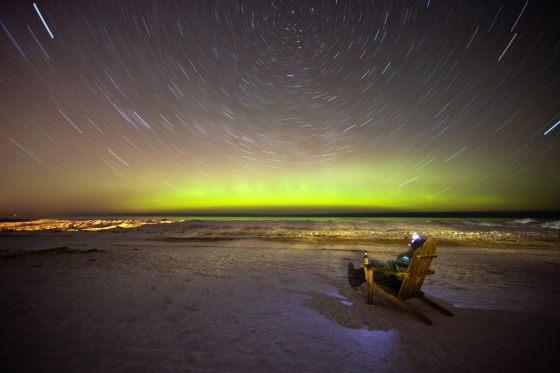 Astrophotographer Shawn Malone of Marquette, Mich., took this shot of an aurora on Feb. 18. Malone appears in the photo seated in the chair.