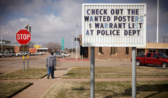 A sign in Hale Center, Texas, advertises the Great Texas Warrant Roundup. 