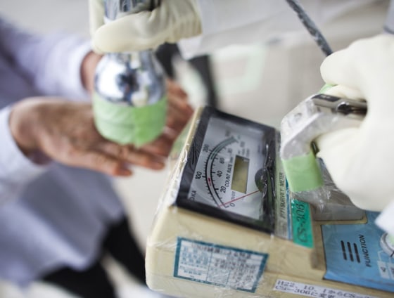 A local man, who lived around the 20-kilometer exclusion zone around the Fukushima Dai-Ichi Nuclear Power Plant, undergoes a test for possible radiation.