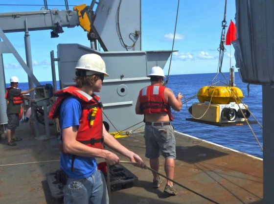 Researchers drop a seismograph off the side of a research ship to the ocean floor 18,000 feet below, near the Mariana Trench. The instrument will stay in place for a year, using rumbles from distant earthquakes to create a picture of the Earth's interior.