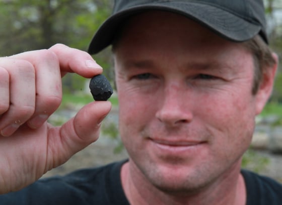 Image: Robert Ward displays one of two pieces of a meteorite he found at a park in Lotus, Calif.