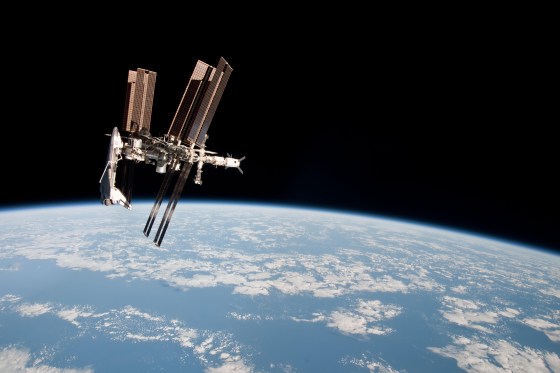 NASA's space shuttle Endeavour appears to hang off one end of the International Space Station in this photo taken by an astronaut aboard a nearby Soyuz spacecraft on May 23, 2011 during Endeavour's final mission. It is one of the first-ever images of a space shuttle docked at the space station.