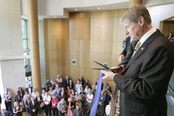 Image: Russ Wasendorf cuts a ribbon in Cedar Falls