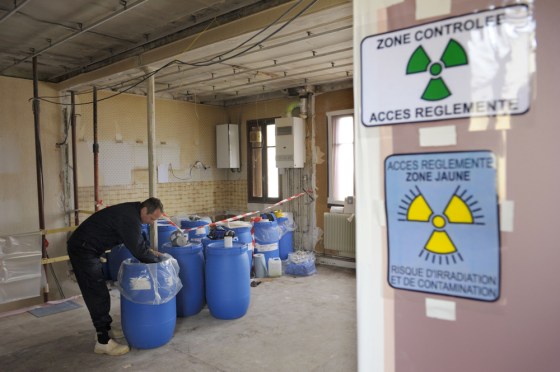 Image: A nuclear waste professional inspects house