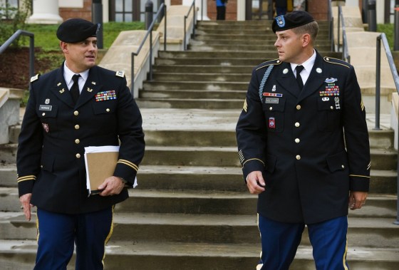 Image: U.S. Army Sgt. Adam Holcomb, right, of Youngstown, Ohio, speaks with his defense attorney Capt. Dennis Hernon.
